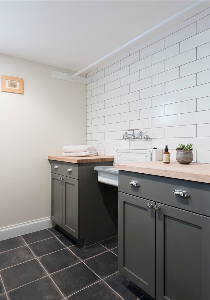 Example of a mid-sized transitional galley dedicated laundry room design in Denver with an utility sink, recessed-panel cabinets, gray cabinets, wood countertops and a side-by-side washer/dryer