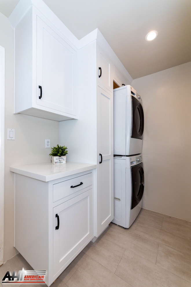 Medium sized modern single-wall separated utility room in Los Angeles with raised-panel cabinets, white cabinets, quartz worktops, beige walls, porcelain flooring, a stacked washer and dryer, beige floors and white worktops.