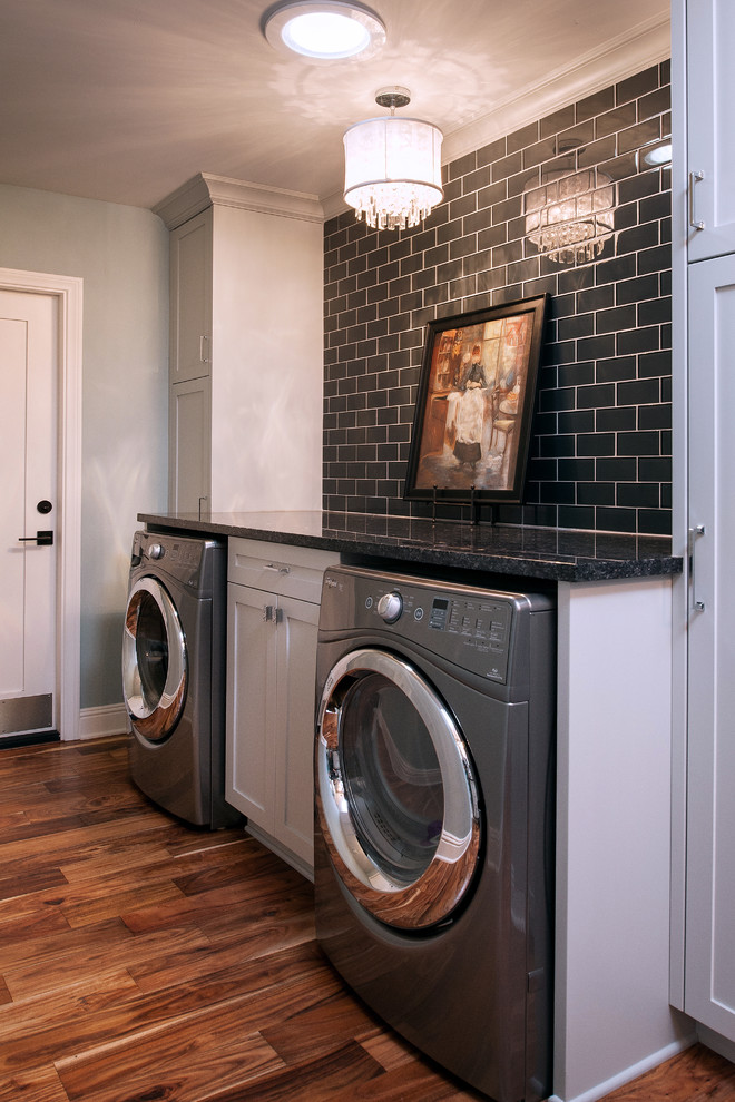 Example of a mid-sized transitional galley medium tone wood floor dedicated laundry room design in San Diego with shaker cabinets, white cabinets, quartz countertops, blue walls and a side-by-side washer/dryer