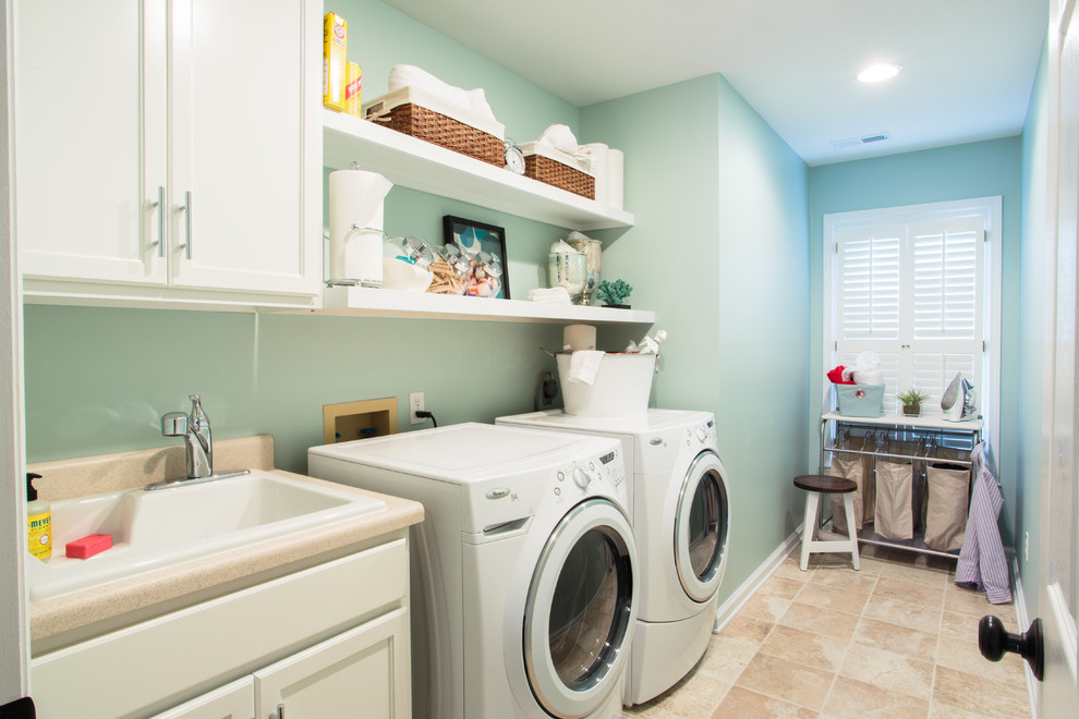 Example of a classic laundry room design in Other with blue walls