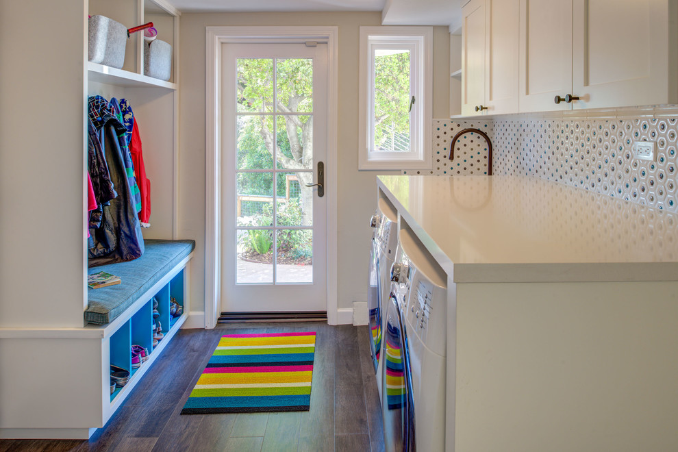 Example of a mid-sized trendy galley dark wood floor and brown floor dedicated laundry room design in San Francisco with an utility sink, shaker cabinets, white cabinets, quartz countertops, white walls, a side-by-side washer/dryer and white countertops