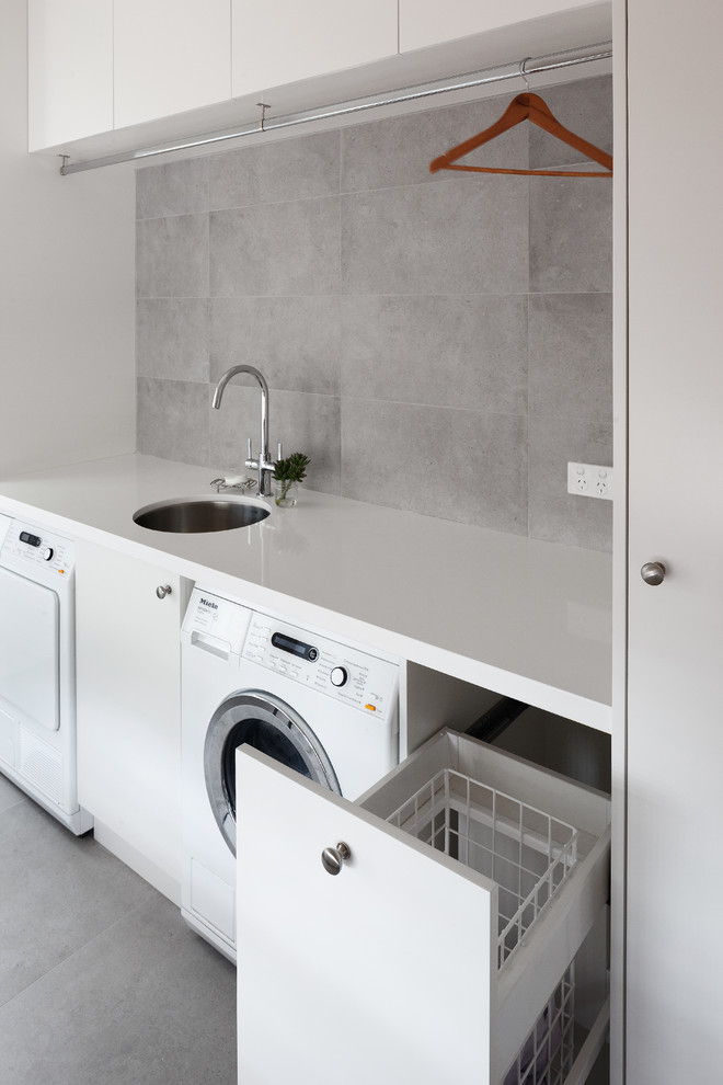 Inspiration for a contemporary utility room in Perth with a submerged sink, flat-panel cabinets, white cabinets, engineered stone countertops, a side by side washer and dryer and white worktops.