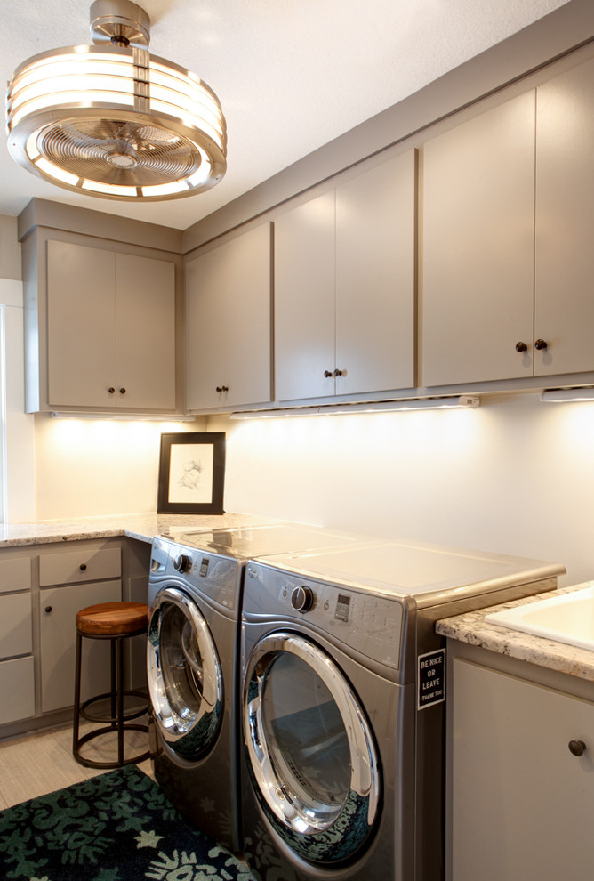 Foto di una sala lavanderia chic di medie dimensioni con lavello da incasso, ante lisce, pareti bianche, pavimento con piastrelle in ceramica e lavatrice e asciugatrice affiancate