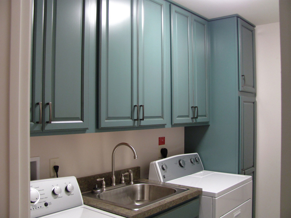 Photo of a small modern single-wall utility room in Baltimore with raised-panel cabinets, laminate countertops and blue cabinets.