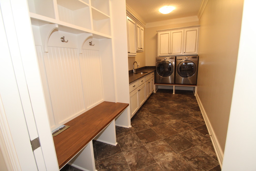 Inspiration for a traditional l-shaped utility room in Other with raised-panel cabinets, grey cabinets, engineered stone countertops, beige walls, ceramic flooring and a side by side washer and dryer.