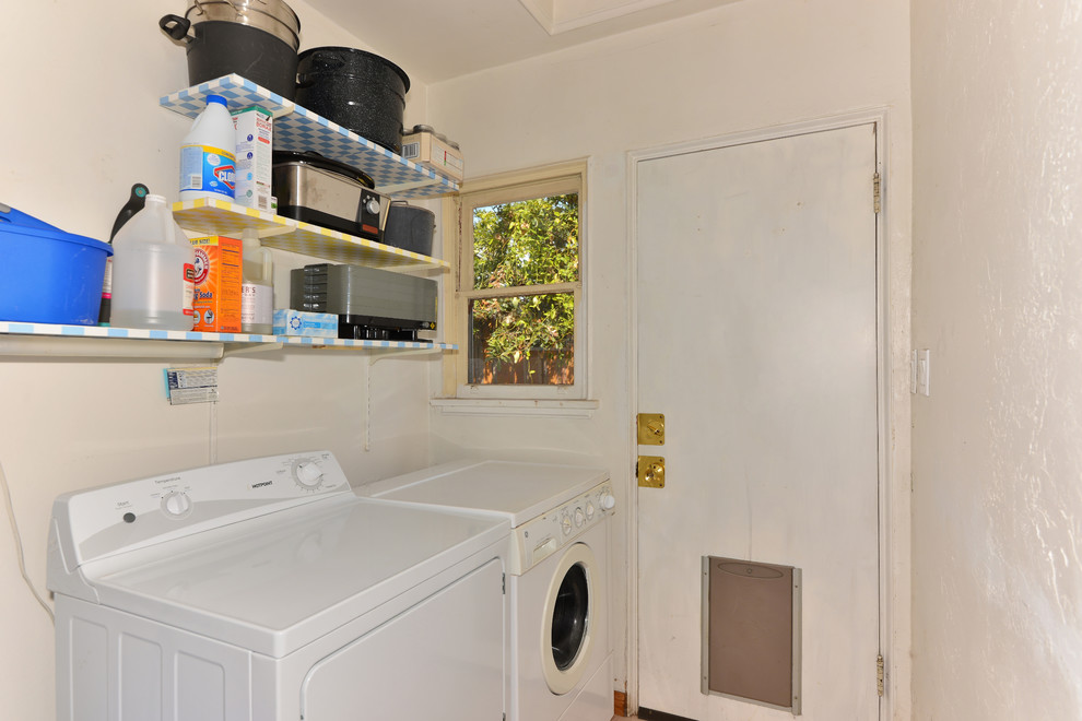 Inspiration for a small mediterranean dedicated laundry room remodel in San Diego with white walls and a side-by-side washer/dryer