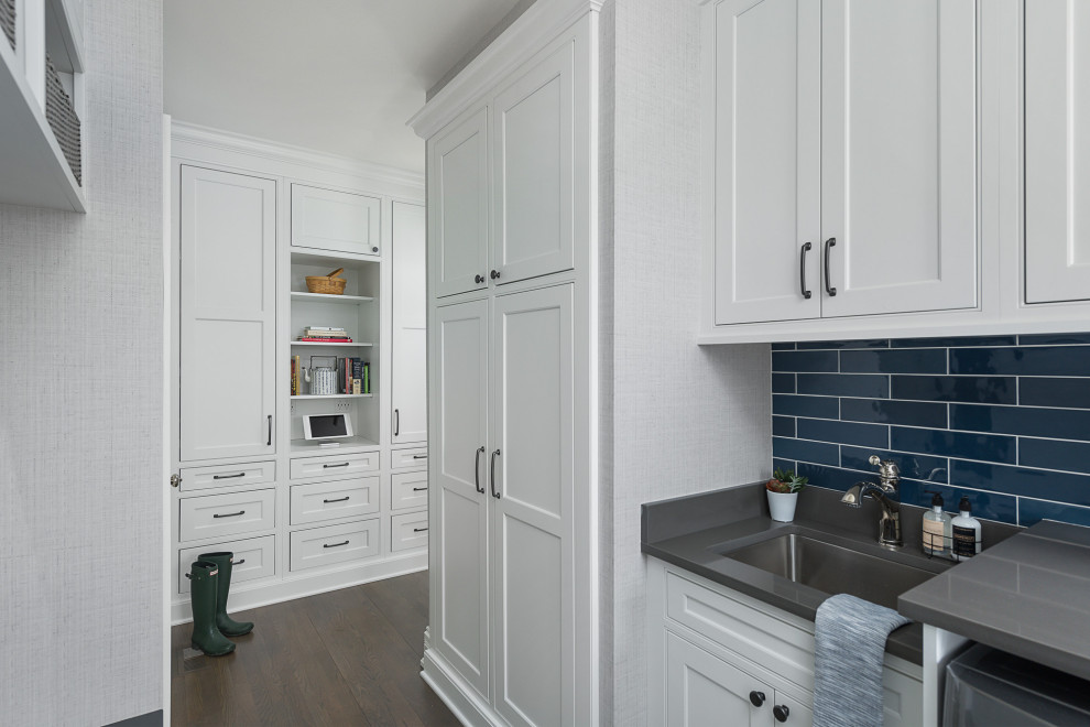 Inspiration for a mid-sized transitional galley medium tone wood floor and brown floor utility room remodel in Chicago with an undermount sink, beaded inset cabinets, white cabinets, quartz countertops, gray walls, a side-by-side washer/dryer and gray countertops