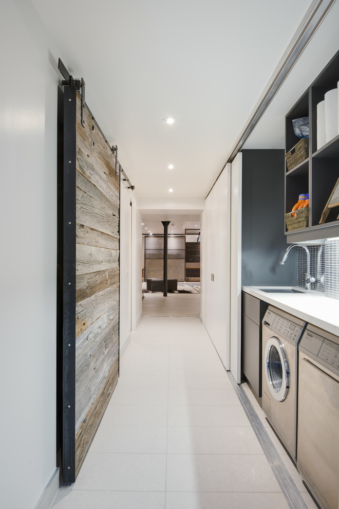 Inspiration for a medium sized single-wall laundry cupboard in Toronto with open cabinets, white cabinets, composite countertops and a side by side washer and dryer.