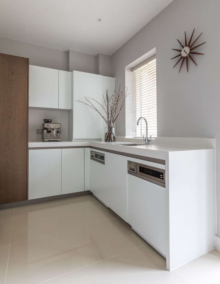 Inspiration for a small contemporary utility room in Cambridgeshire with a submerged sink, flat-panel cabinets, white cabinets, quartz worktops, grey walls, ceramic flooring and beige floors.