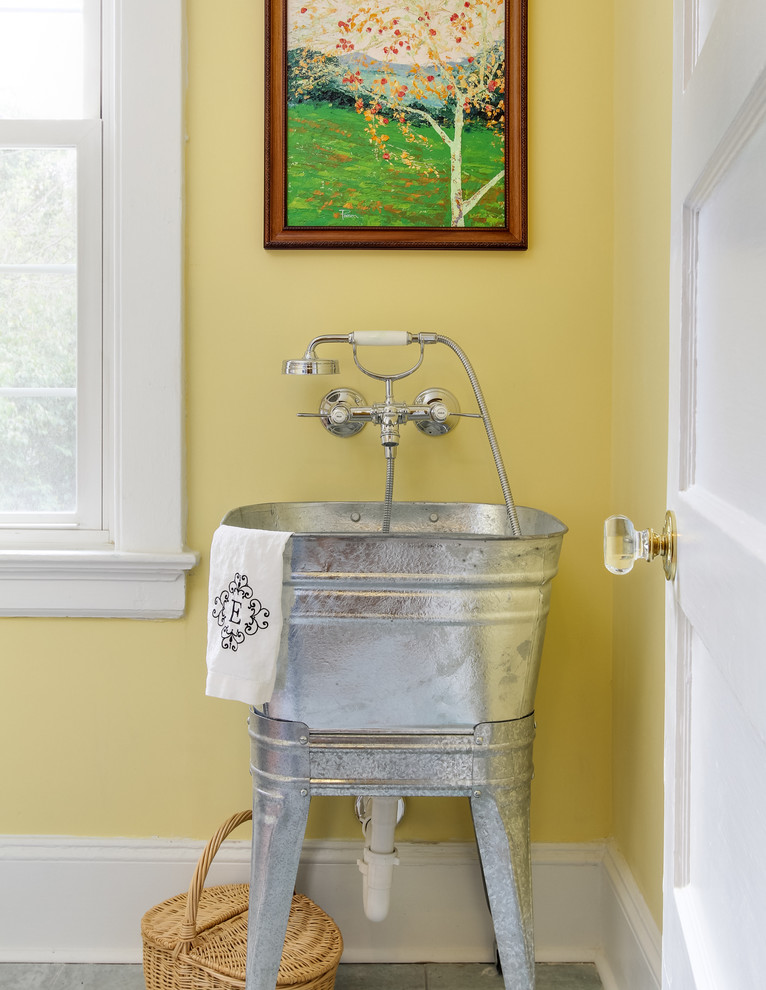 Example of a transitional laundry room design in Raleigh with an utility sink and yellow walls
