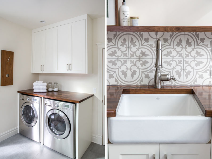 Klassisk inredning av en stor tvättstuga enbart för tvätt, med en rustik diskho, luckor med infälld panel, vita skåp, träbänkskiva, vita väggar, klinkergolv i porslin, en tvättmaskin och torktumlare bredvid varandra och grått golv