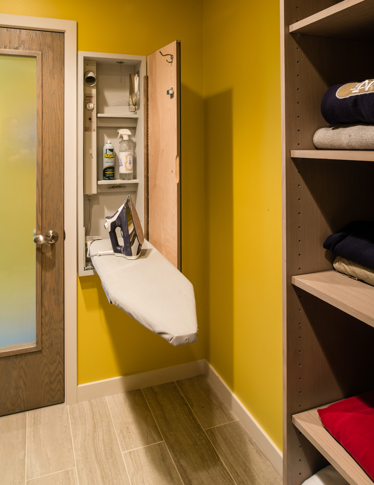 Laundry room - contemporary laundry room idea in Other with yellow walls