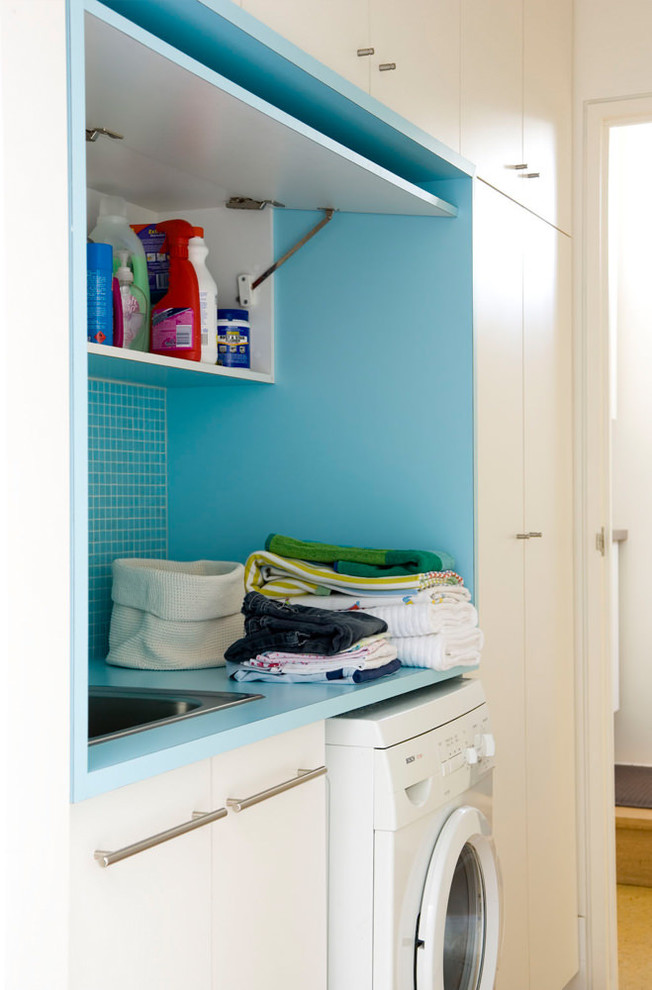 Laundry room - small contemporary laundry room idea in Adelaide with flat-panel cabinets and white cabinets