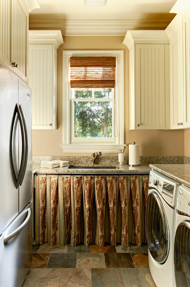 Elegant utility room photo in Charlotte with a side-by-side washer/dryer