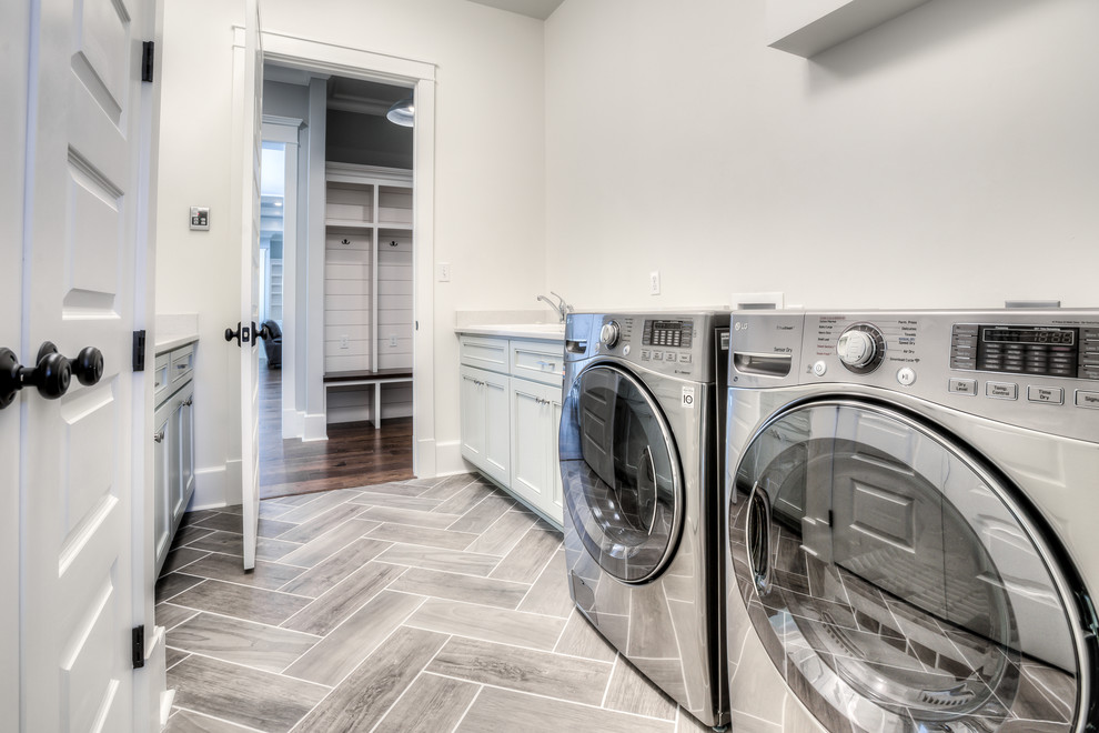 Inspiration for a mid-sized craftsman galley porcelain tile laundry room remodel in Atlanta with a drop-in sink, quartz countertops, gray walls, a side-by-side washer/dryer and gray cabinets