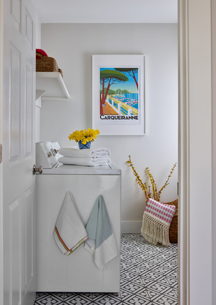 Foto de cuarto de lavado tradicional renovado de tamaño medio con paredes blancas, suelo de baldosas de cerámica, lavadora y secadora juntas y suelo negro