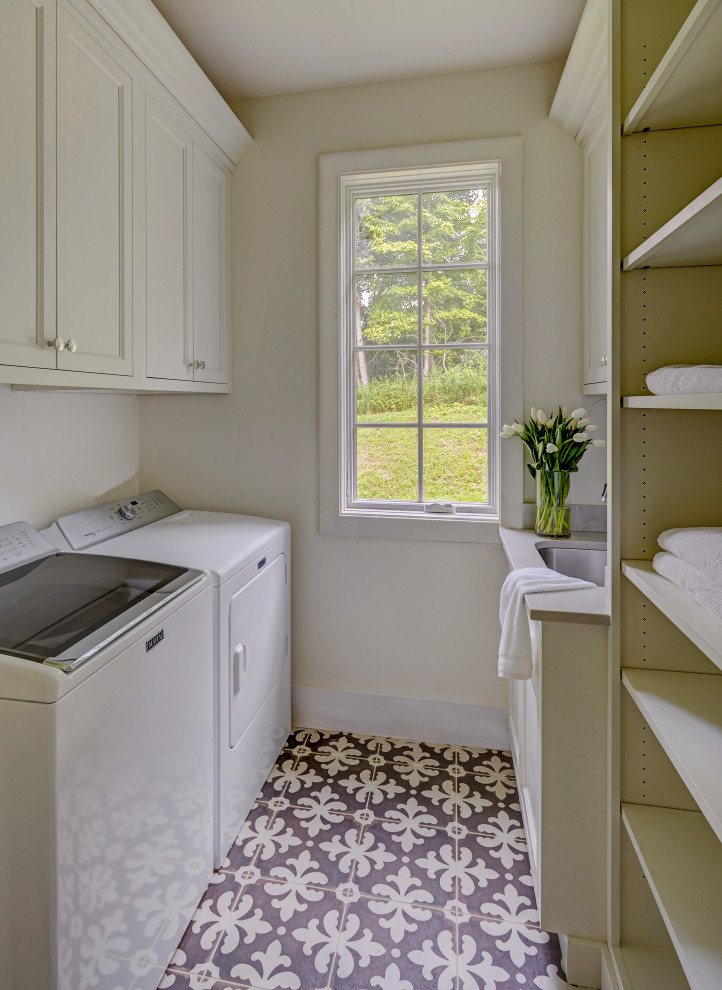 Photo of a traditional galley separated utility room in Other with a submerged sink, shaker cabinets, white cabinets, engineered stone countertops, white walls, porcelain flooring, a side by side washer and dryer, multi-coloured floors and grey worktops.