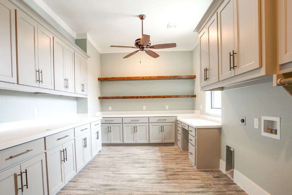 Inspiration for a large farmhouse u-shaped ceramic tile and brown floor utility room remodel in Dallas with shaker cabinets, gray cabinets, granite countertops, green walls and a side-by-side washer/dryer