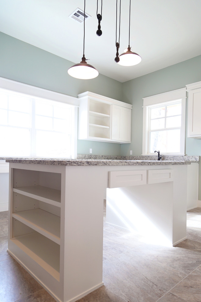 Example of a large country l-shaped ceramic tile and beige floor dedicated laundry room design in Other with an undermount sink, shaker cabinets, white cabinets, granite countertops and blue walls