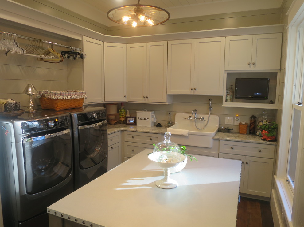 Dedicated laundry room - mid-sized cottage l-shaped medium tone wood floor dedicated laundry room idea in Atlanta with a farmhouse sink, flat-panel cabinets, white cabinets, granite countertops, beige walls and a side-by-side washer/dryer