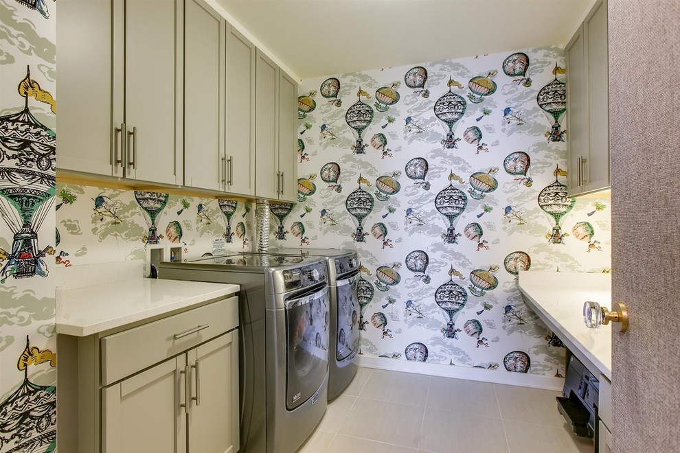 Example of a large trendy galley ceramic tile dedicated laundry room design in Nashville with shaker cabinets, beige cabinets, solid surface countertops, multicolored walls and a side-by-side washer/dryer