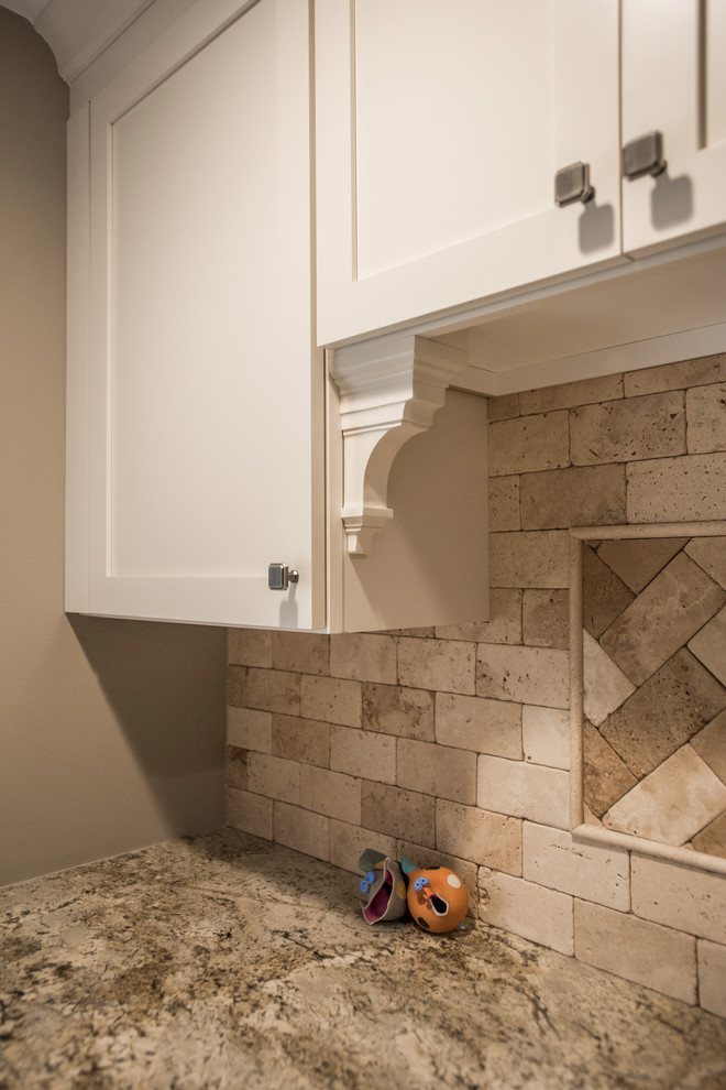 Photo of a large classic u-shaped utility room in Other with a submerged sink, shaker cabinets, white cabinets, granite worktops, medium hardwood flooring and brown floors.