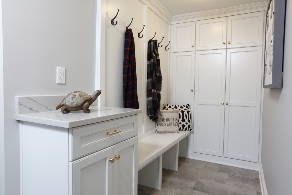 Example of a mid-sized transitional porcelain tile and gray floor laundry room design in Cleveland with shaker cabinets, white cabinets, quartzite countertops, gray walls and white countertops