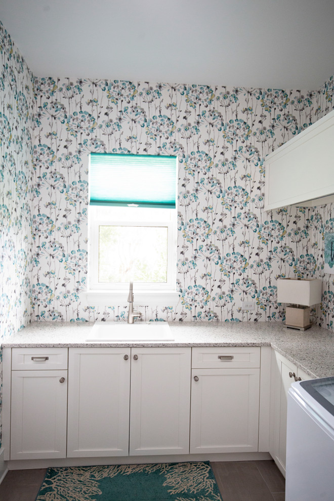 Dedicated laundry room - mid-sized coastal l-shaped ceramic tile, beige floor and wallpaper dedicated laundry room idea in Miami with a drop-in sink, shaker cabinets, white cabinets, quartzite countertops, a side-by-side washer/dryer and beige countertops