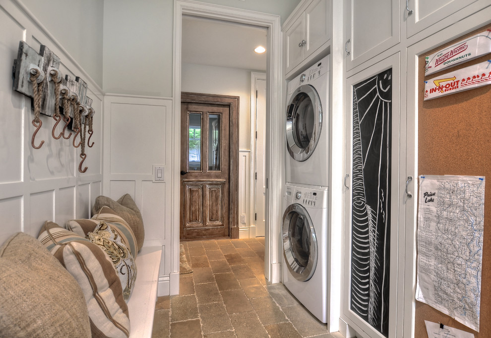 Classic utility room in Orange County with a stacked washer and dryer.