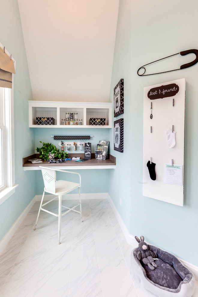 Inspiration for a large nautical single-wall utility room in Other with a built-in sink, recessed-panel cabinets, white cabinets, laminate countertops, blue walls, marble flooring and a side by side washer and dryer.