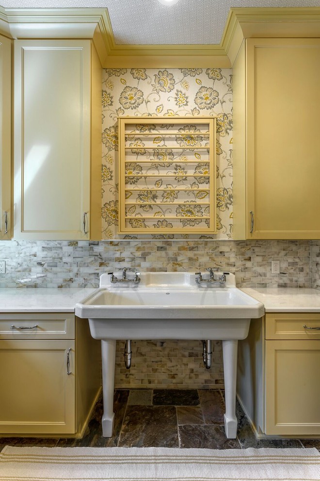 Inspiration for a large farmhouse slate floor and gray floor dedicated laundry room remodel in Detroit with recessed-panel cabinets, yellow cabinets and quartzite countertops