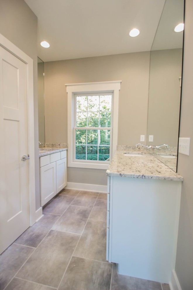 Inspiration for a timeless galley porcelain tile dedicated laundry room remodel in Other with an undermount sink, shaker cabinets, white cabinets, granite countertops and beige walls