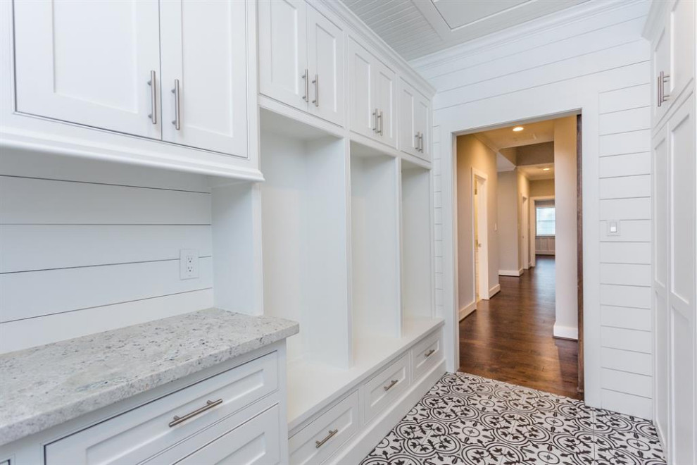 Large minimalist ceramic tile, multicolored floor, shiplap ceiling and shiplap wall laundry room photo in Houston with white cabinets, granite countertops, white backsplash, wood backsplash, white walls, a side-by-side washer/dryer, multicolored countertops, an undermount sink and shaker cabinets