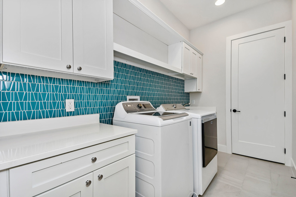 Inspiration for a mid-sized modern galley ceramic tile and gray floor dedicated laundry room remodel in Orlando with shaker cabinets, white cabinets, quartz countertops, gray walls, a side-by-side washer/dryer and white countertops