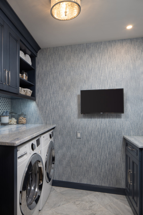 small transitional galley marble floor, white floor and wallpaper dedicated laundry room remodel in Other with a drop-in sink, beaded inset cabinets, blue cabinets, marble countertops, multicolored backsplash, porcelain backsplash, blue walls, a side-by-side washer/dryer and gray countertops