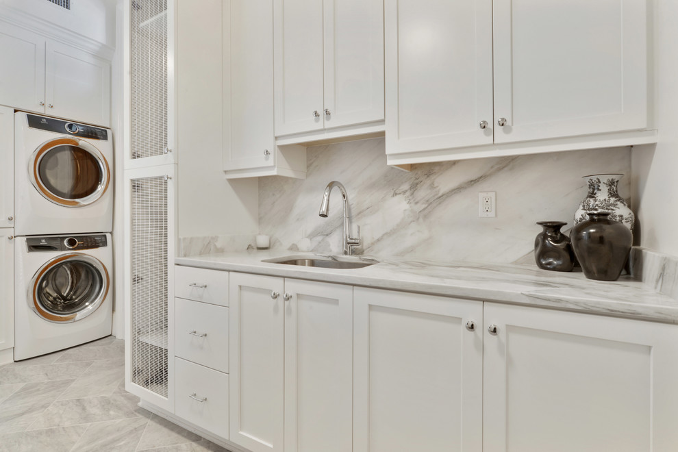 Photo of a classic utility room in New Orleans with shaker cabinets and white cabinets.