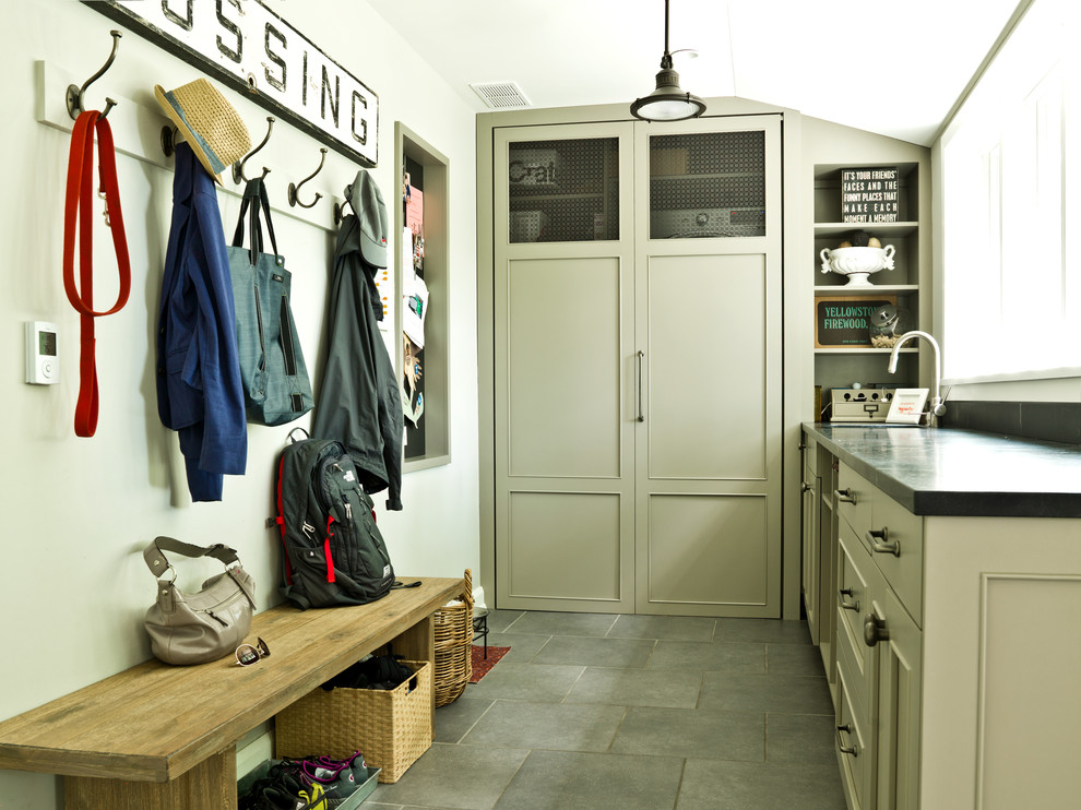 Inspiration for a transitional slate floor laundry room remodel in Chicago with recessed-panel cabinets and gray cabinets