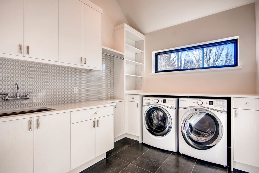 Contemporary utility room in Denver with flat-panel cabinets and white cabinets.
