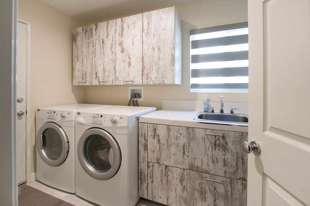 Laundry room - small contemporary porcelain tile and white floor laundry room idea in Los Angeles with a drop-in sink, flat-panel cabinets, medium tone wood cabinets, quartz countertops, beige walls and a side-by-side washer/dryer