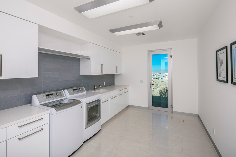 Example of a large minimalist single-wall marble floor and gray floor kitchen design in Phoenix with an undermount sink, flat-panel cabinets, white cabinets and quartzite countertops