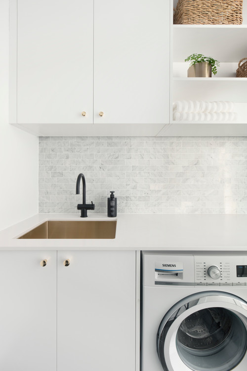 Modern Appeal: Contemporary Laundry Room with Gray Backsplash Tiles and White Cabinets