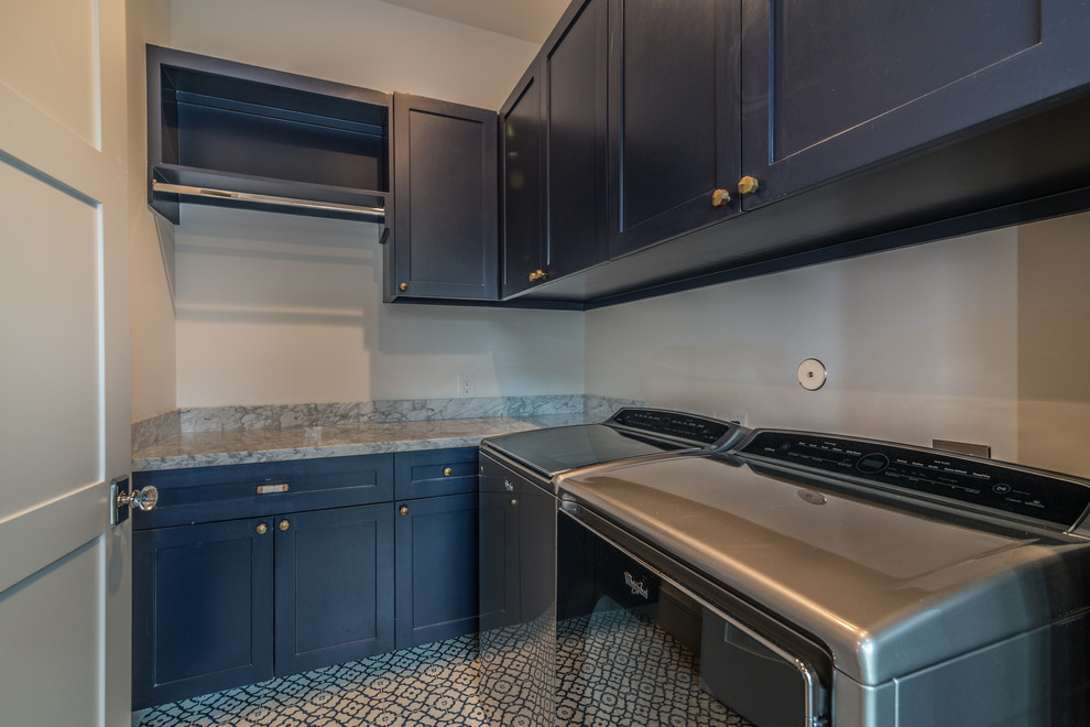 Medium sized modern l-shaped utility room with shaker cabinets, blue cabinets, granite worktops, grey walls and a side by side washer and dryer.
