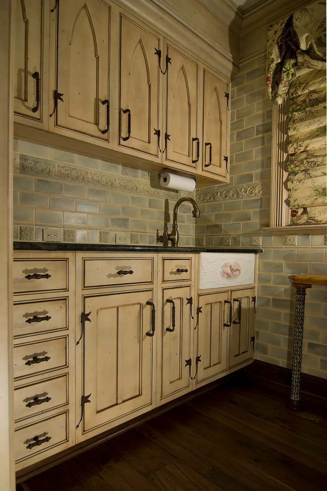 Photo of a small traditional utility room in Other with granite worktops, blue walls, dark hardwood flooring, a submerged sink, brown floors, brown worktops, beaded cabinets and beige cabinets.
