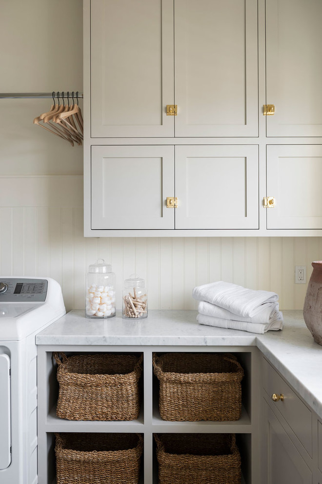 Inspiration for a large nautical l-shaped separated utility room in Salt Lake City with grey cabinets, marble worktops, white walls, ceramic flooring, a side by side washer and dryer, grey floors and multicoloured worktops.