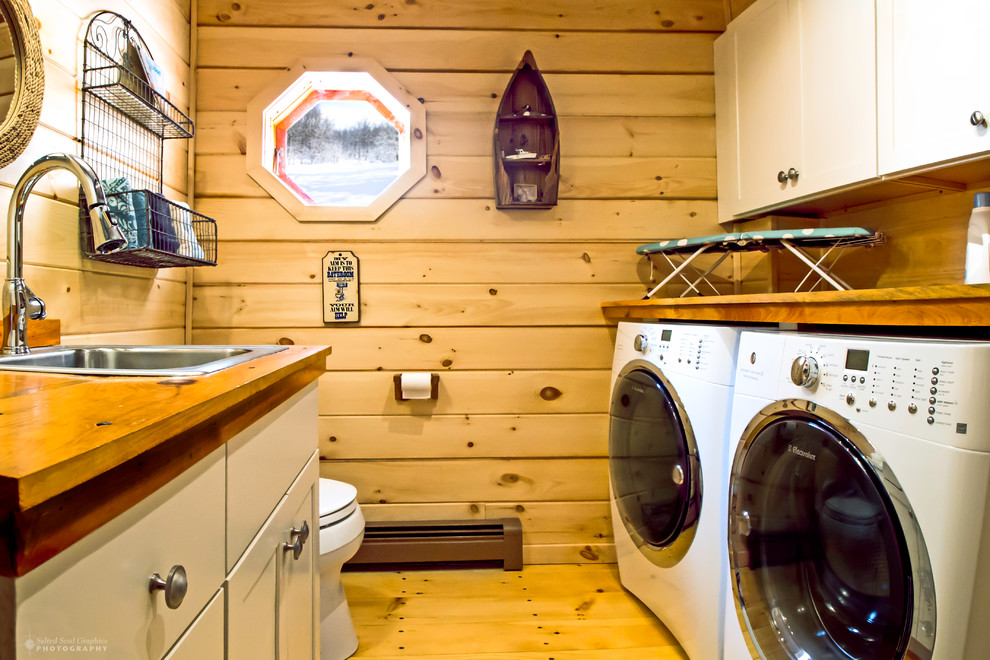 Design ideas for a small traditional galley utility room in Burlington with shaker cabinets, beige cabinets, wood worktops, a side by side washer and dryer, a built-in sink, brown walls and light hardwood flooring.