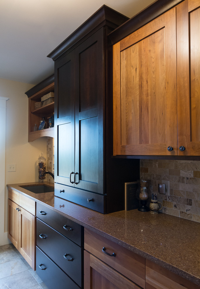Inspiration for a large craftsman galley slate floor and brown floor utility room remodel in Portland Maine with a drop-in sink, shaker cabinets, granite countertops, beige walls, a side-by-side washer/dryer and medium tone wood cabinets