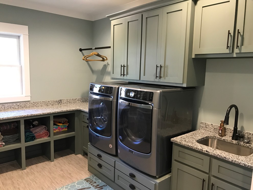 Design ideas for a medium sized traditional separated utility room in Raleigh with shaker cabinets, grey cabinets, granite worktops, grey walls, vinyl flooring, a side by side washer and dryer and beige floors.