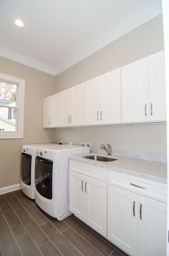 Dedicated laundry room - mid-sized transitional single-wall ceramic tile dedicated laundry room idea in DC Metro with an undermount sink, shaker cabinets, white cabinets, marble countertops, gray walls and a side-by-side washer/dryer