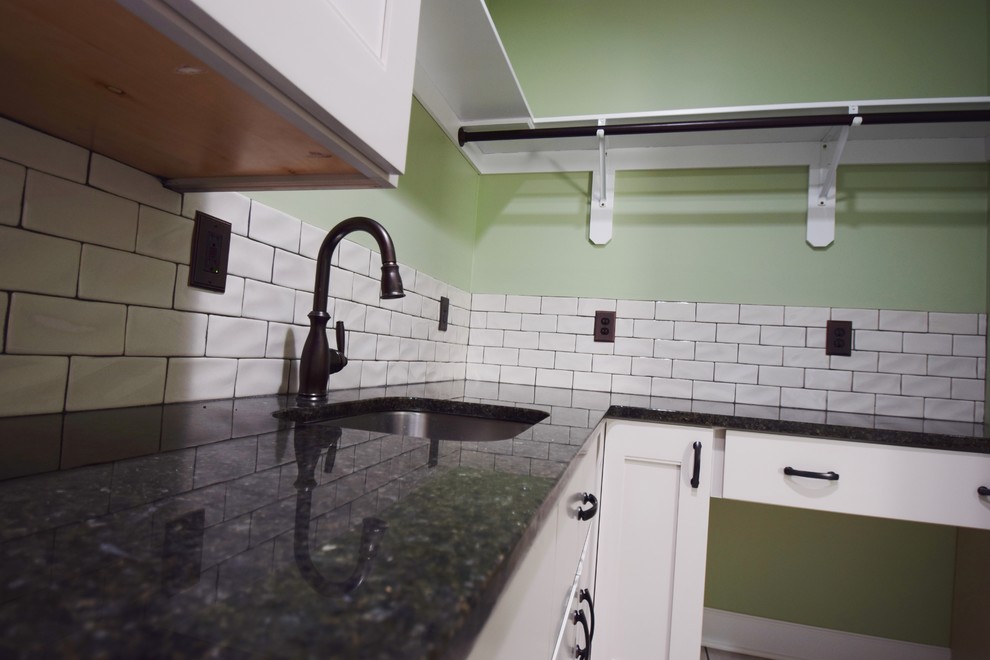Inspiration for a small l-shaped utility room in Kansas City with a submerged sink, granite worktops, green walls, ceramic flooring, a side by side washer and dryer and white floors.