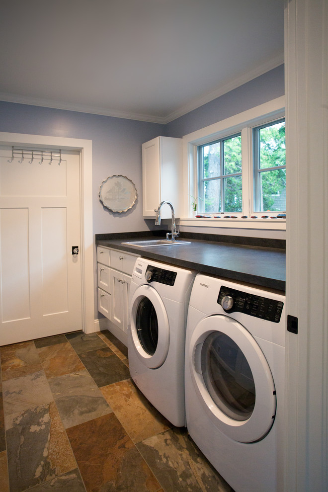 Inspiration for a single-wall separated utility room in Other with a built-in sink, white cabinets, slate flooring, a side by side washer and dryer and grey worktops.